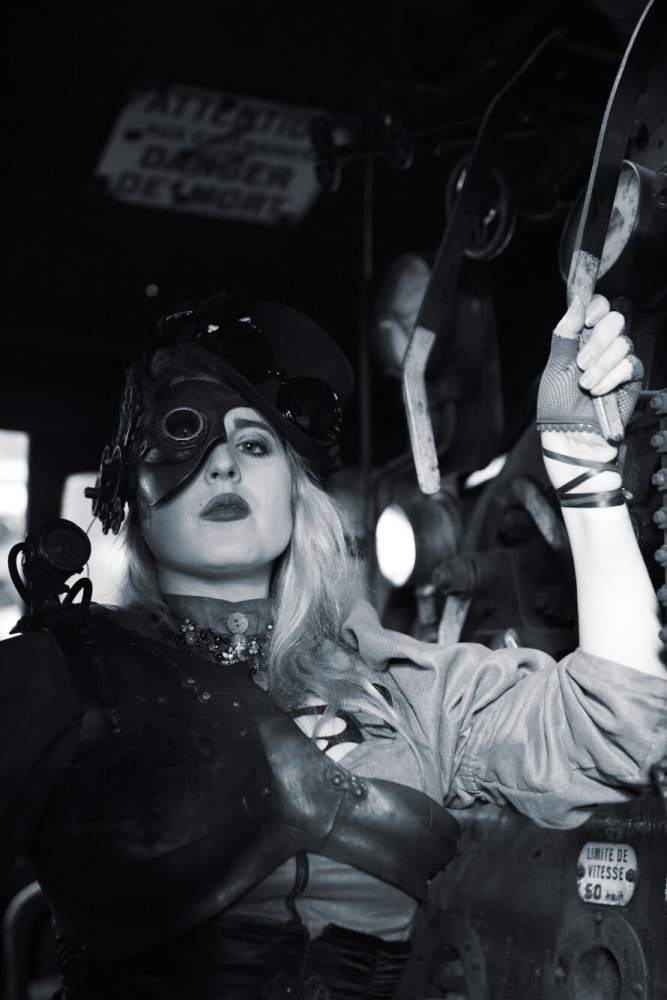femme portrait en costume steampunk dans une ancienne locomotive noir et blanc