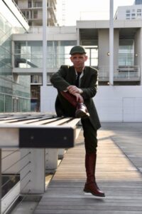 Homme lifestyle en costume kaki et casquette sur un banc de la BNF