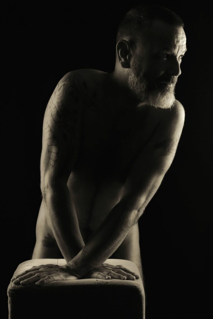 Séance photo pour modèle homme expérimenté tatoué barbu en nu artistique avec Lorentz appuyé clair obscur profil noir et blanc
