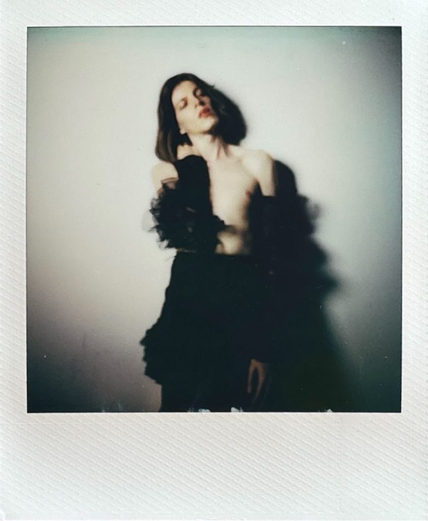 Louis modèle androgyne homme féminin polaroid séance photo par femme photographe céline pivoine eyes au studio photo location à Montreuil 93 près de Fontenay sous bois en jupe et gants longs debout