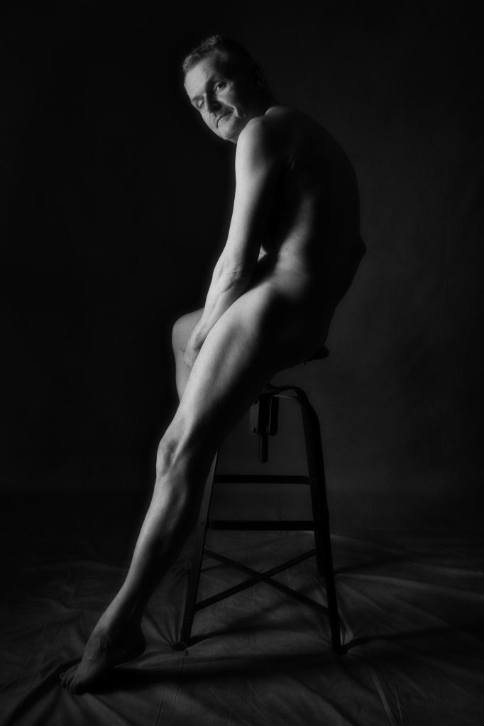 Séance photo estime de soi nu artistique pour homme mature sénior silver avec Jean-Yves en noir et blanc au studio photo de Céline Pivoine Eyes femme photographe à Montreuil 93 près de Paris profil sur tabouret