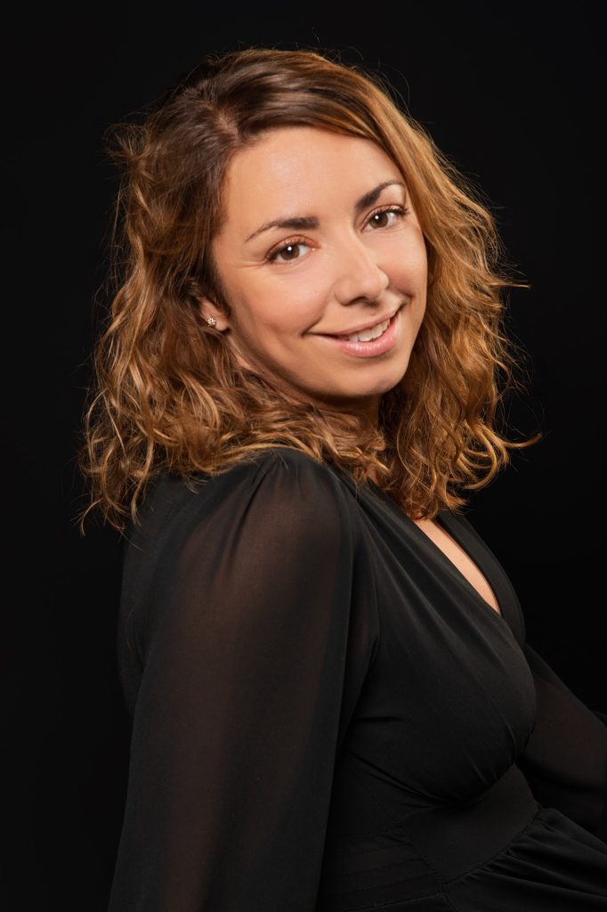 Séance portrait estime de soi avec Vanessa souriante en robe noire de profil